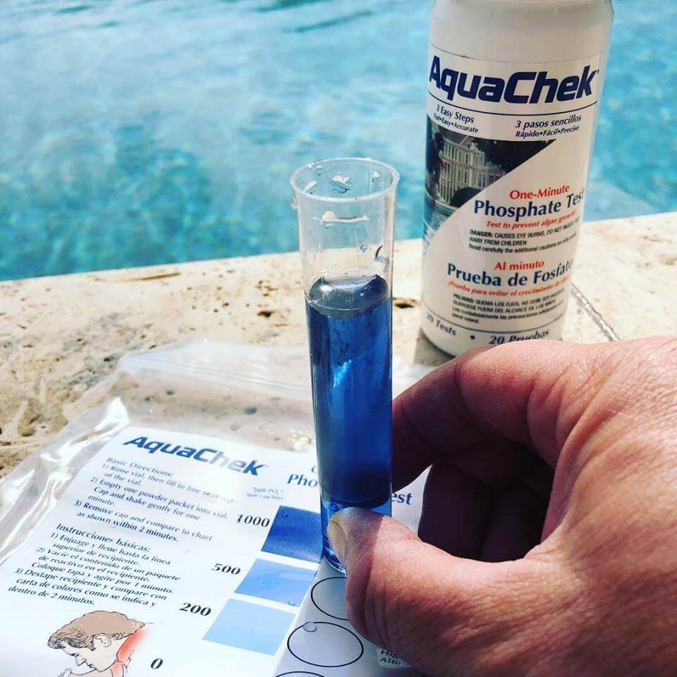 Swimming Pool Chemicals in a test tube near a pool