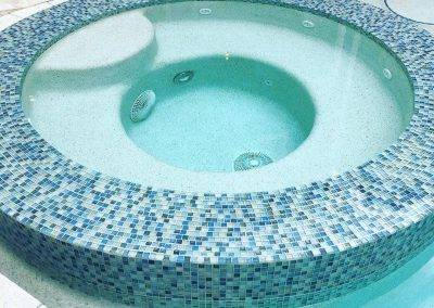 pool tile renovation - spillover spa with glass tiles